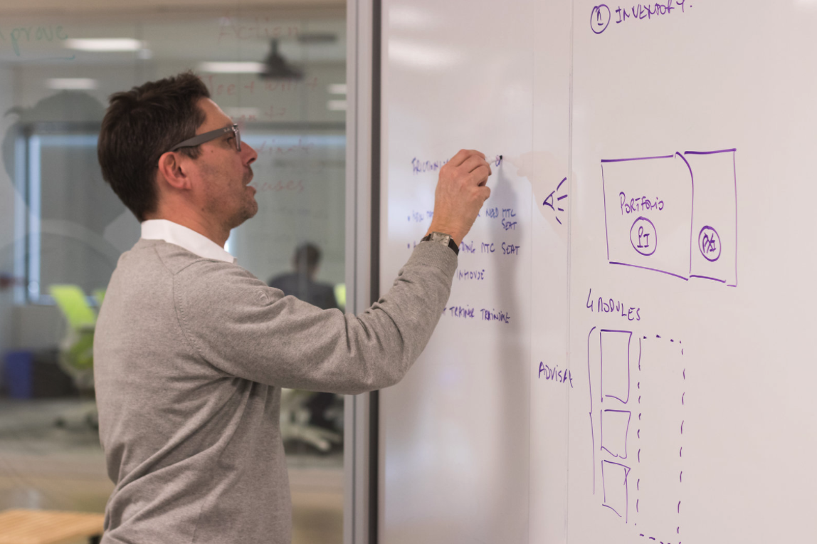 Man writing on whiteboard