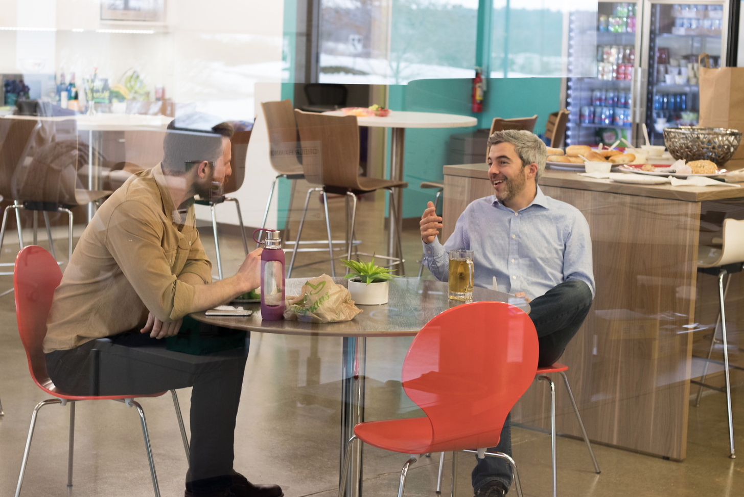 Coworkers laughing and eating lunch