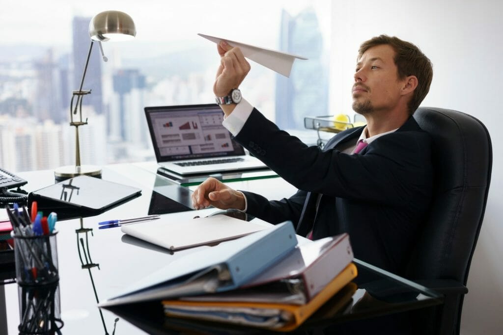 Employee throwing paper airplane