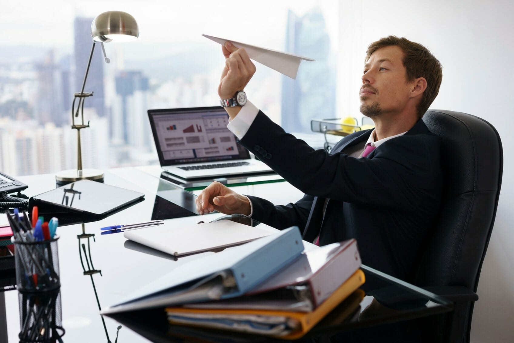 Employee throwing paper airplane