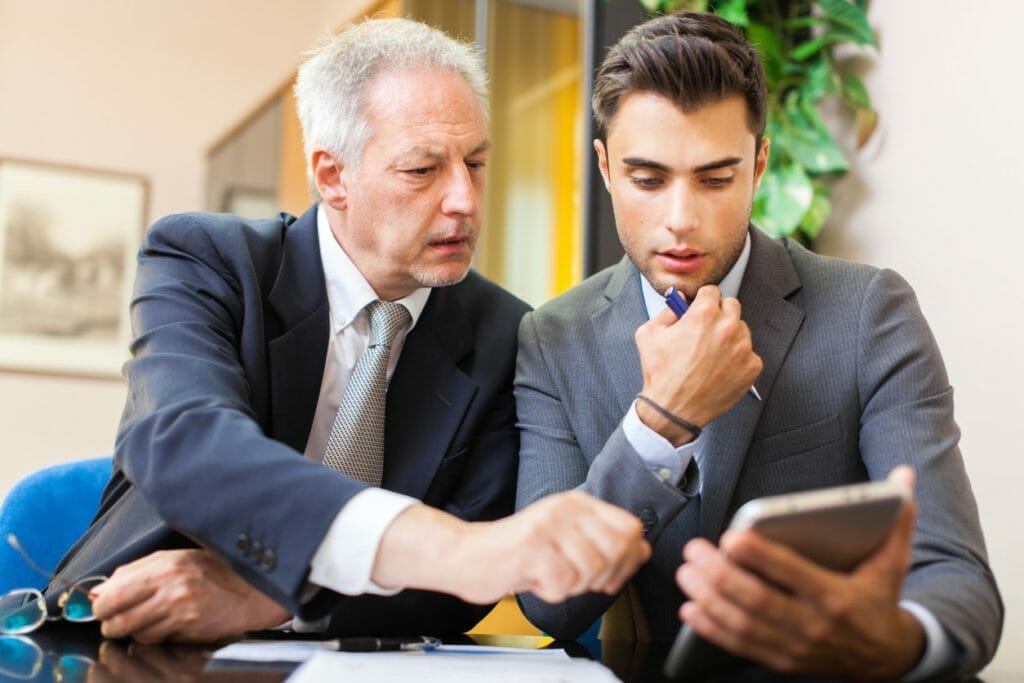 Men looking at info on tablet