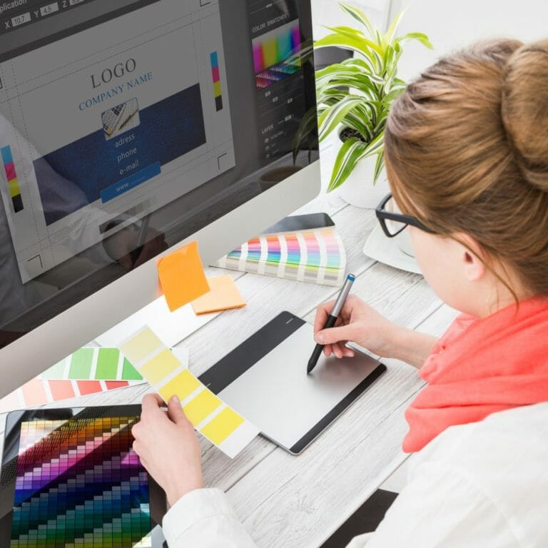Employee creating logo on computer