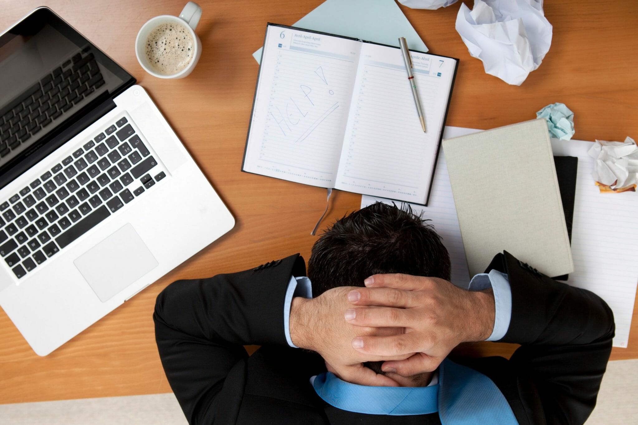 Employee with head down on desk