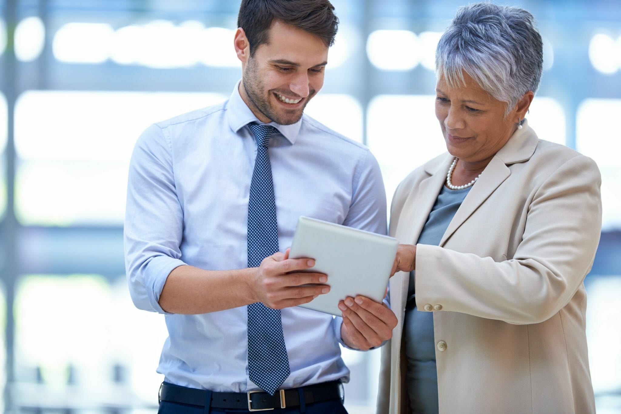 Two coworkers looking at information