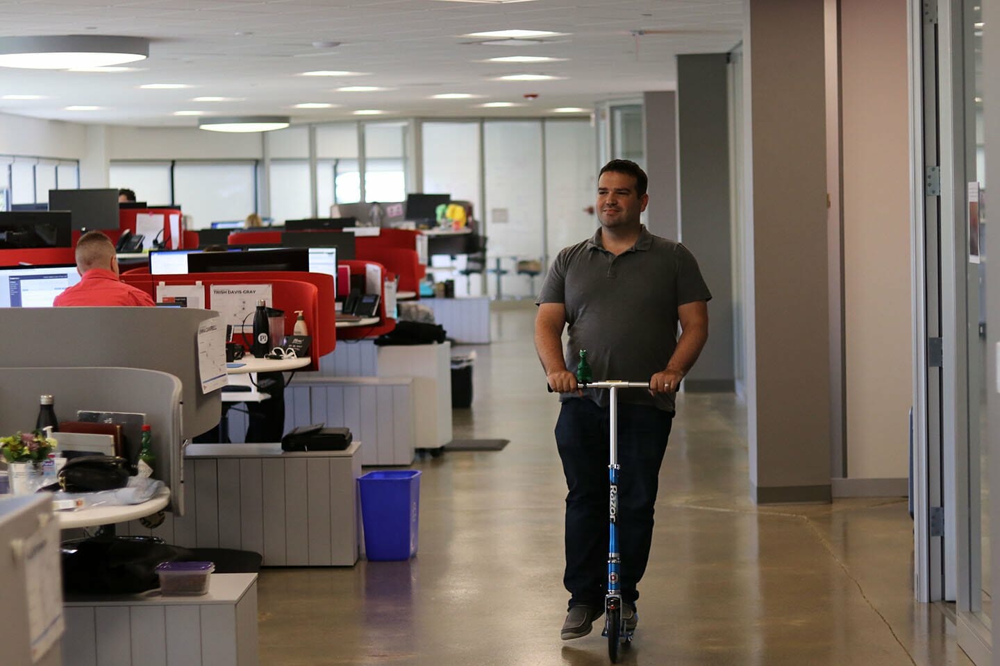 man on scooter in office