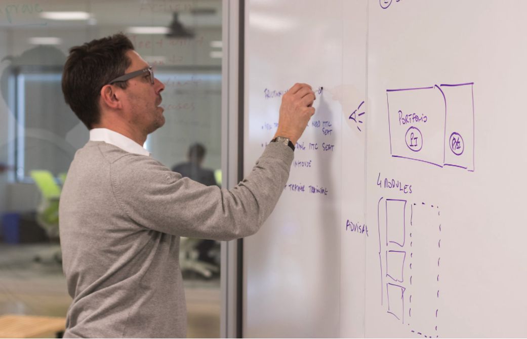 Man writing on white board