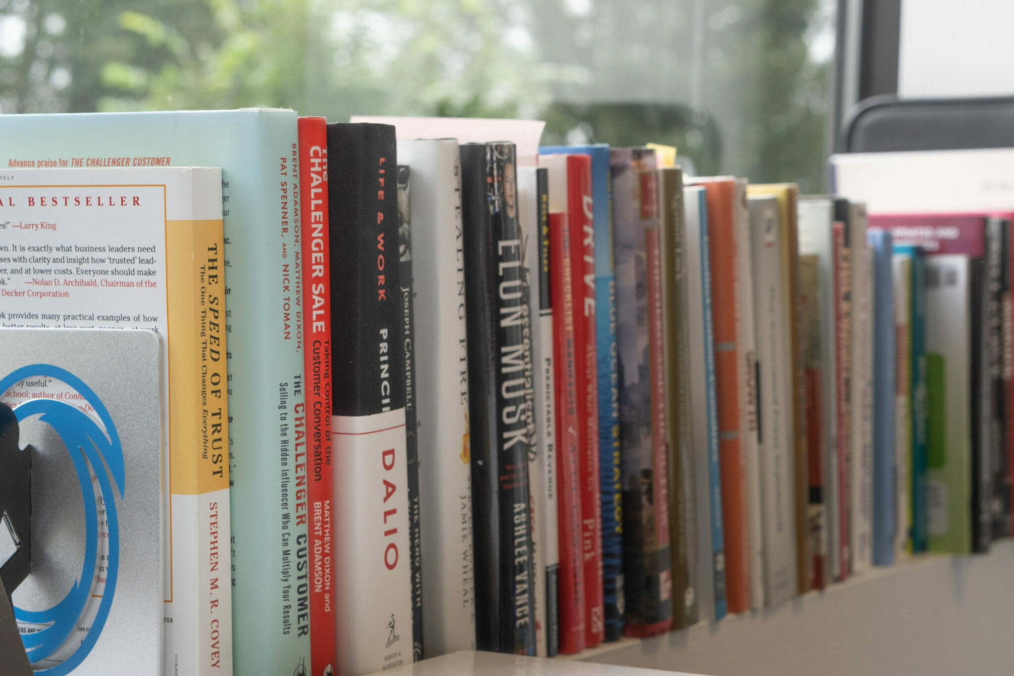 leadership books on a shelf in Drew's office