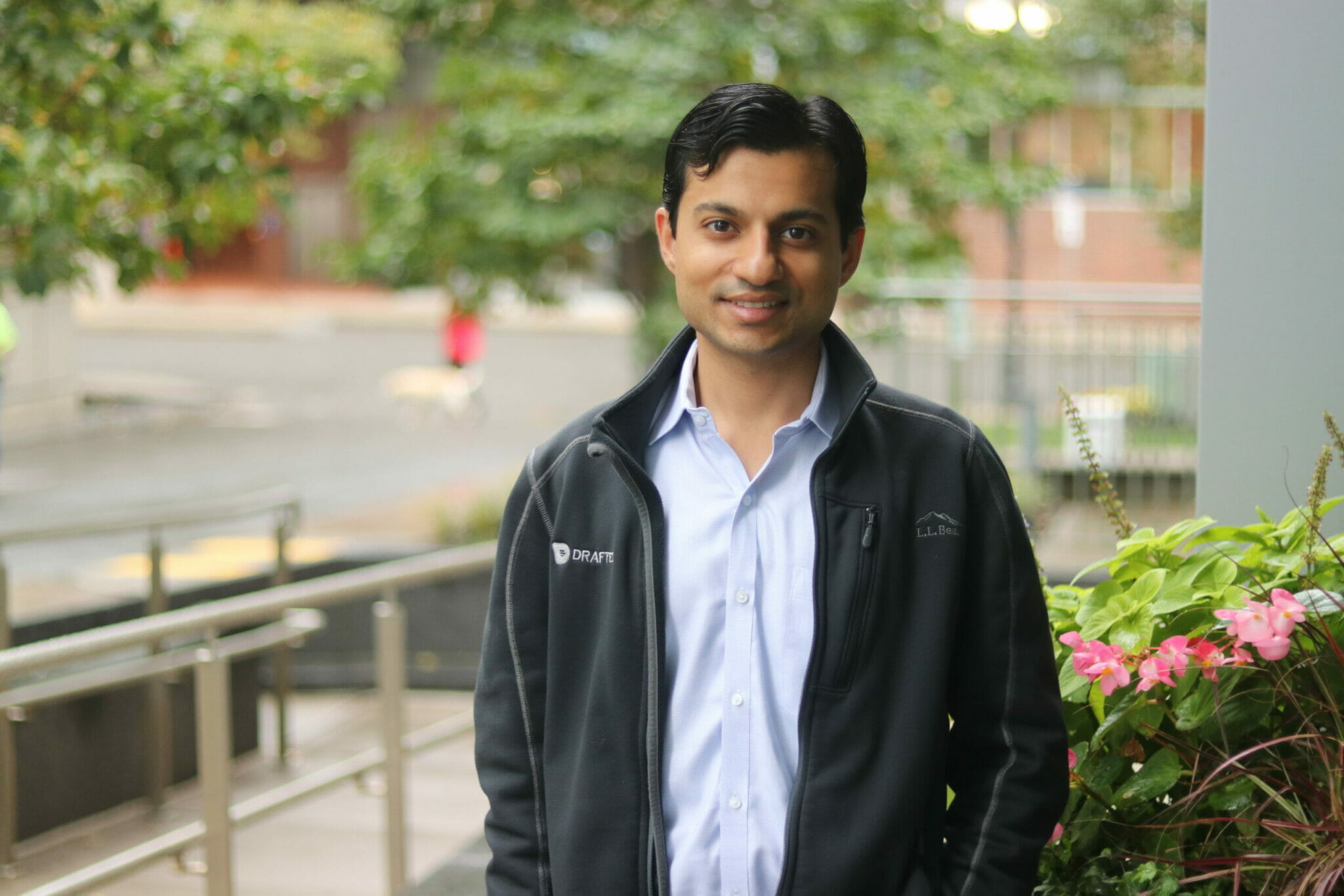 Vinayak stands outside workplace