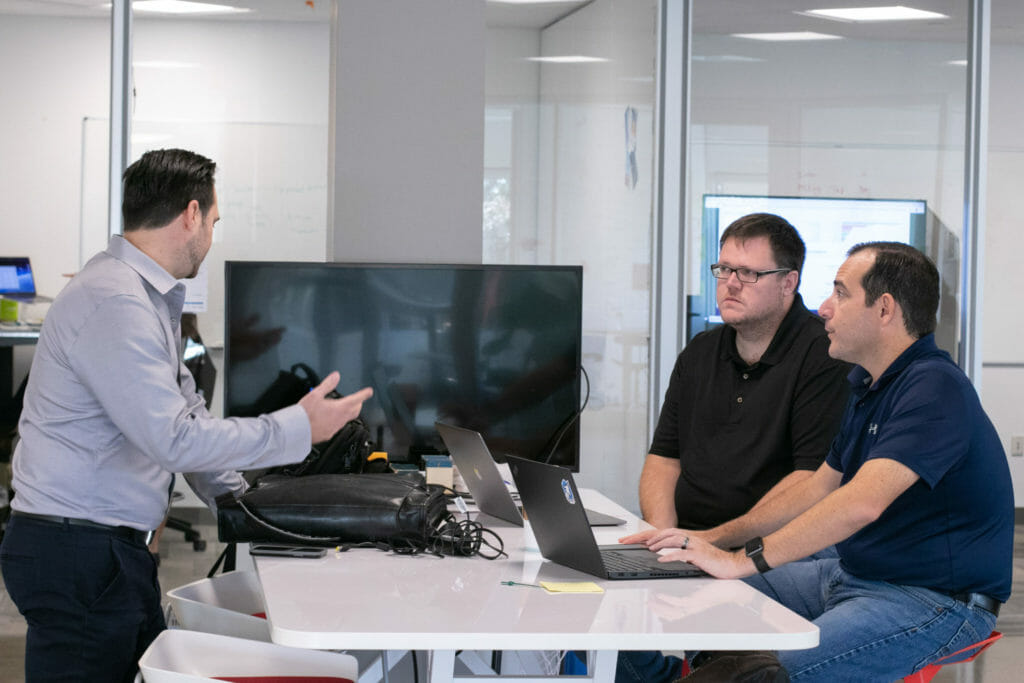 manufacturing employees discussing common problems in the industry
