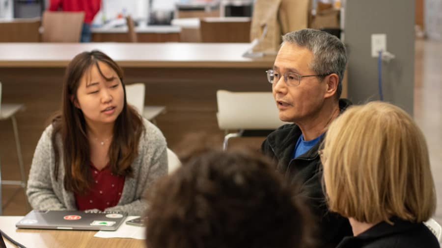 PI employees sitting in on a team meeting