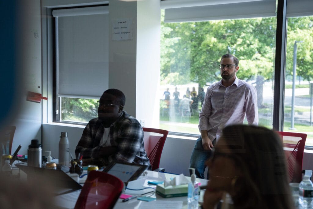 People listen during a company meeting
